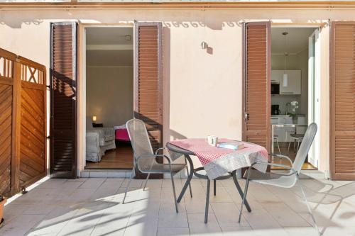 a patio with a table and chairs on a balcony at Rodrigo Lakeside Suits in Griante Cadenabbia