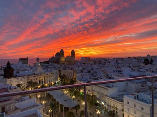 a view of a city at sunset at Skyline - Penthouse with 50m2 private terrace and stunning views in Cádiz