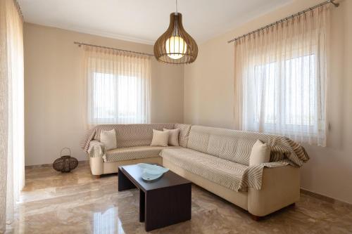 a living room with a couch and a table at IL PARADISO DI MICHAIL in Phanaes