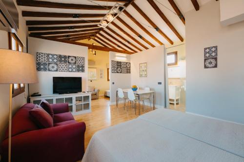 a living room filled with furniture and a tv at Top2Stay Málaga in Málaga