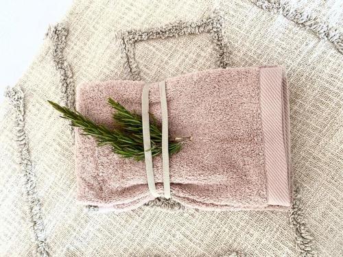 a pink towel with a green plant on it at Villa Med - private pool, garden, sun all day, stunning views in Albufeira