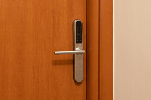 a metal door handle on a wooden door at BED&BREAD Piazza 'Nzegna in Carovigno