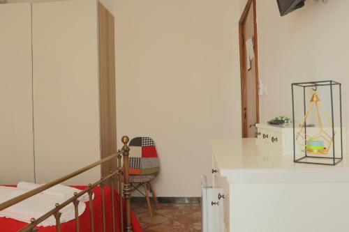 a bedroom with a bed and a chair in a room at BED&BREAD Piazza 'Nzegna in Carovigno