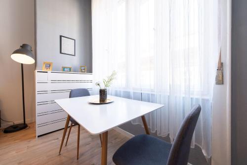 a dining room with a white table and chairs at BUDAPEST4U - New apt in the central of Budapest in Budapest