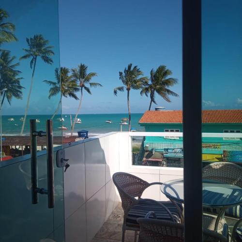 a view of the ocean from the balcony of a resort at Flat Galemares in Maragogi