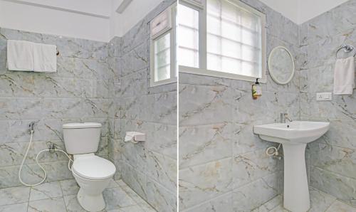 a bathroom with a toilet and a sink at Treebo Green Land Kushalnagar in Kushālnagar