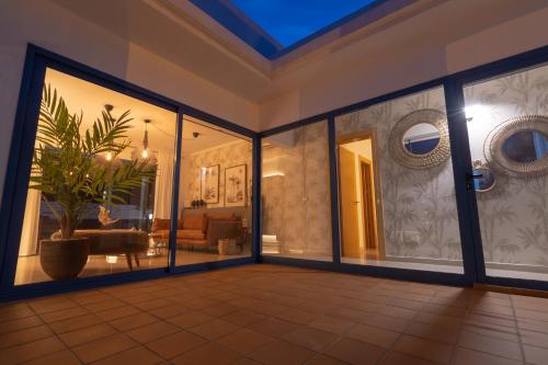 a living room with glass doors and a potted plant at Villalia Zaida in Playa Blanca
