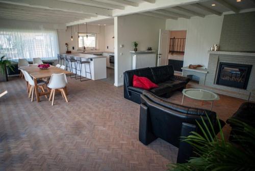 a living room with a couch and a table at Vakantiewoning Renee in Wenduine