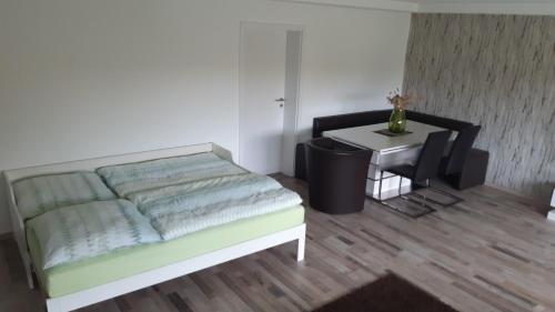 a bedroom with a bed and a small table at Fewo Traumblick in Kreuzwertheim