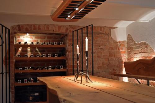 a wine cellar with a wooden table and candles at Ronnums Herrgård in Vargön