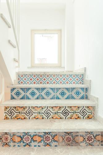 a room with colorful tiles on the stairs at Hotel Villa Paradiso in Taormina