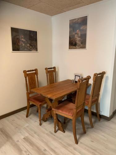 a wooden dining room table and chairs in a room at VikingBnB in Kirke Såby