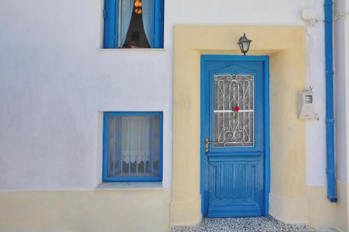 a blue door on the side of a building at Skopelos house in Castle in Panormos Skopelos