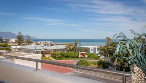 a balcony with a view of the ocean at 5 bedroom Traditional Fisherman's old Gem w panoramic views, Bloubergstrand, Cape Town in Bloubergstrand