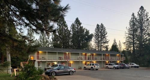 a building with cars parked in a parking lot at Brownsville Motel in Brownsville