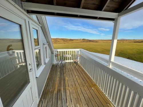 a porch of a house with a bench on it at Hótel Lækur in Hella