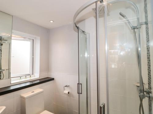 a bathroom with a shower and a toilet at Sandy Toes in Christchurch