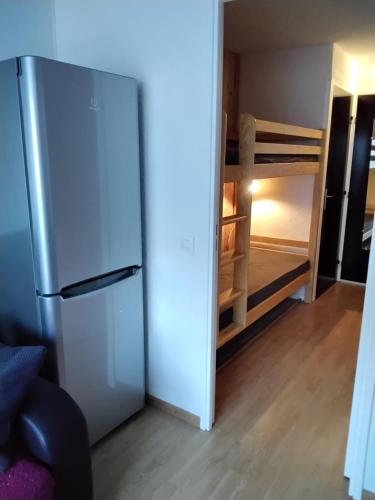 a refrigerator in a room with a bunk bed at STUDIO 20m2 in Puy-Saint-Vincent