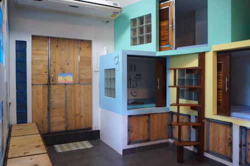 a room with wooden doors and wooden shelves at Sundaze Samet - Bar & Hostel in Ko Samed