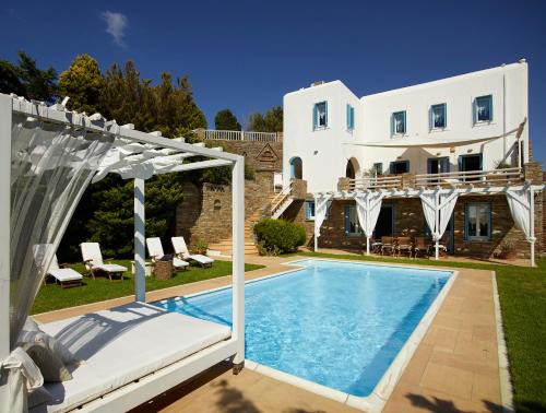 a villa with a swimming pool and a house at Heliades Villas in Gavrio