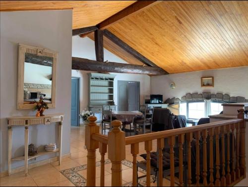 a living room and dining room with a wooden ceiling at Appartement d'exception sur le port pittoresque de Marseillan in Marseillan