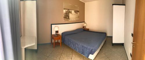 a small bedroom with a bed and a table at Continental Resort in Tirrenia
