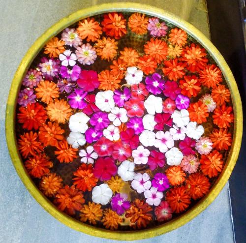 a bowl filled with colorful flowers on a table at Welcomhotel By ITC Hotels, Katra in Katra