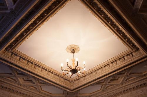 a chandelier hanging from the ceiling of a building at Hotel Schloss Neetzow in Neetzow
