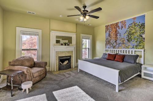 a bedroom with a bed and a chair and a fireplace at Classic Cañon City Getaway - 13 Mi to Royal Gorge! in Canon City