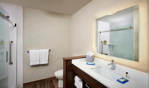 a bathroom with a sink and a toilet and a mirror at Holiday Inn Express - Sarnia - Point Edward by IHG in Sarnia