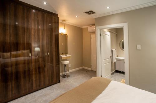 a bedroom with a bed and a bathroom at Stay at The Point- Royal Relaxing Retreat in Durban