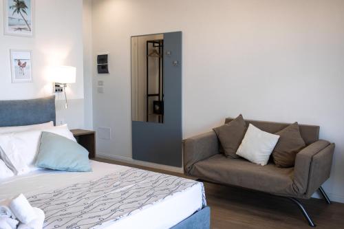 a bedroom with a bed and a couch at 1531 Jackson B&B in Scalea