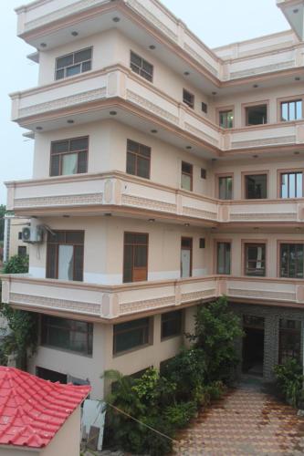 a large white building with a red roof at HOTEL HAIFA in Varanasi
