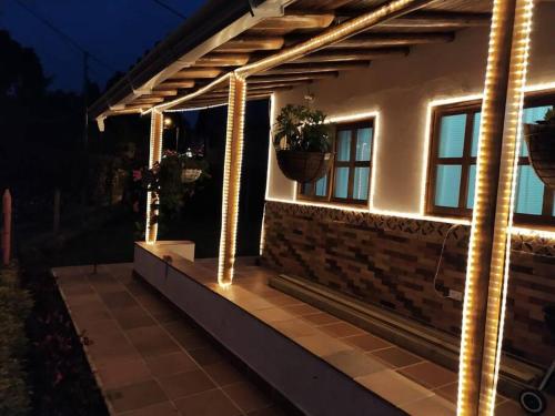 a pergola with lights on a house at night at Samaria, un lugar para descansar y disfrutar in Santa Elena
