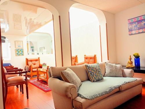 a living room with a couch and chairs at Hotel Maceo Chico in Bogotá