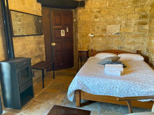 a bedroom with a bed and a wood stove at Pachna Studios - Village Life in Limassol