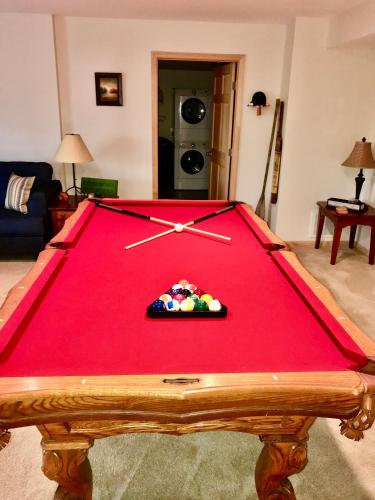 a pool table with a clock on top of it at The Crows Nest in Lake Lure