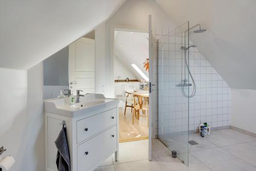 a bathroom with a sink and a shower at Bath tub penthouse in the city in Aalborg