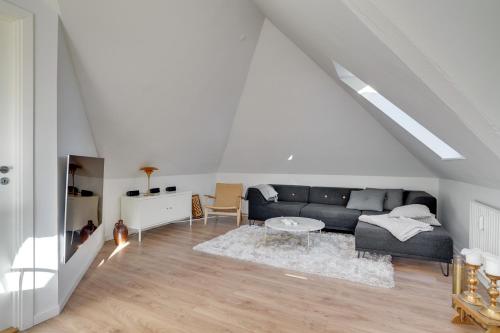 a living room with a couch and a table at Bath tub penthouse in the city in Aalborg