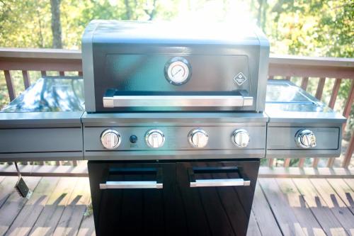 a gas grill with a blue top on a deck at The Crows Nest in Lake Lure