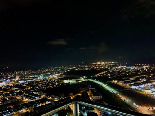 a view of a city at night with lights at The Venus - Spacious Wooden TOP Floor Apartment in Sitiawan