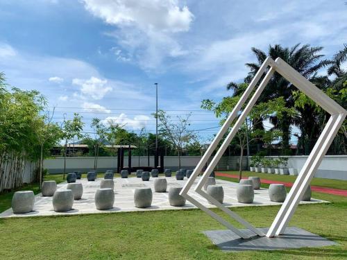 a sculpture in the middle of a park at The Venus - Spacious Wooden TOP Floor Apartment in Sitiawan