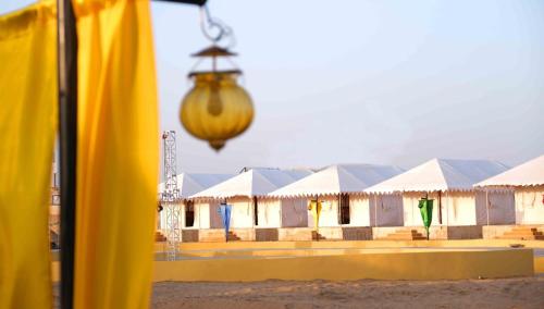 a view of a row of white tents at Excellent Desert Safari camp in Sām