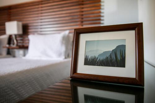 a framed picture of a bed in a bedroom at Comoda Casa Privada in Tequila