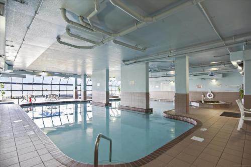 a large swimming pool with blue water in a building at Phoenix 6 Unit 1209 in Orange Beach