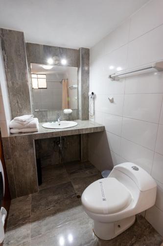 a bathroom with a toilet and a sink at El Portal De San Lázaro in Arequipa