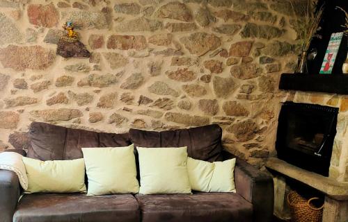 a brown leather couch with two white pillows on it at Eirixo in Valga