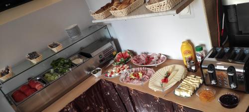a kitchen with a table with plates of food at Pod Różą B&B in Ustka