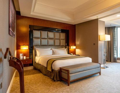 a bedroom with a large bed in a room at Best Plaza West Bay Hotel in Doha