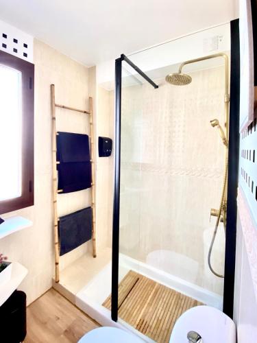 a shower with a glass door in a bathroom at El Capricho in El Ronquillo